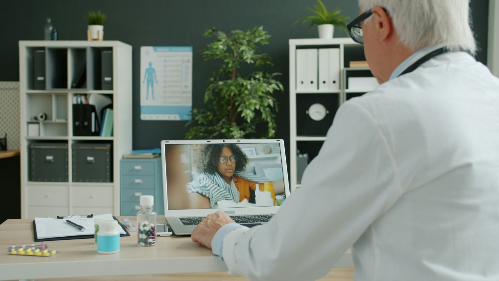 A telehealth care provider speaking virtually with a patient on a computer